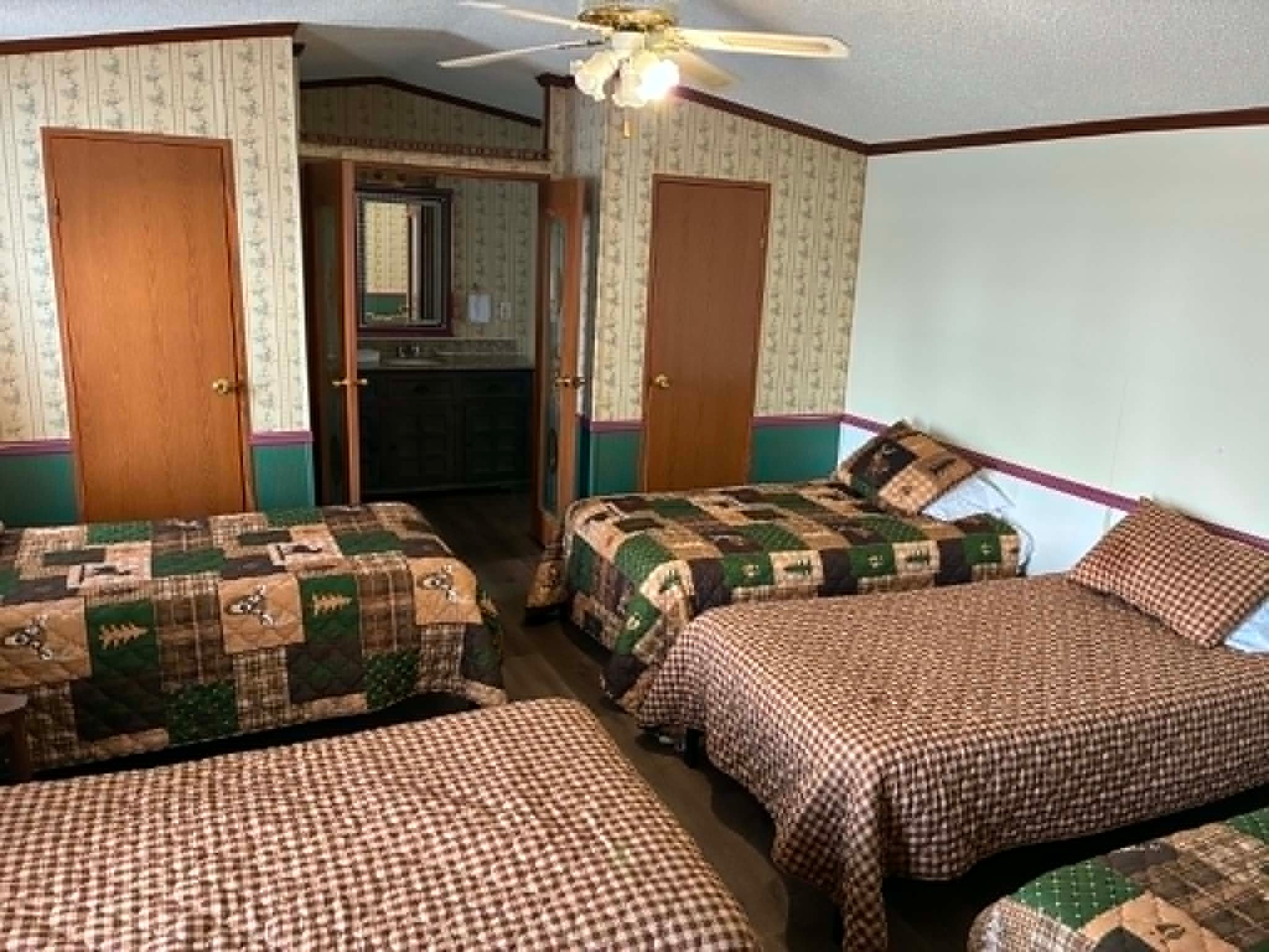 Large Group Lodging third bedroom with multiple beds and lodge bedding