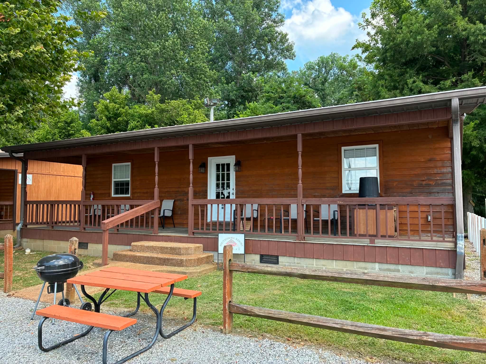 Lakefront Lodging exterior with covered porch and picnic area