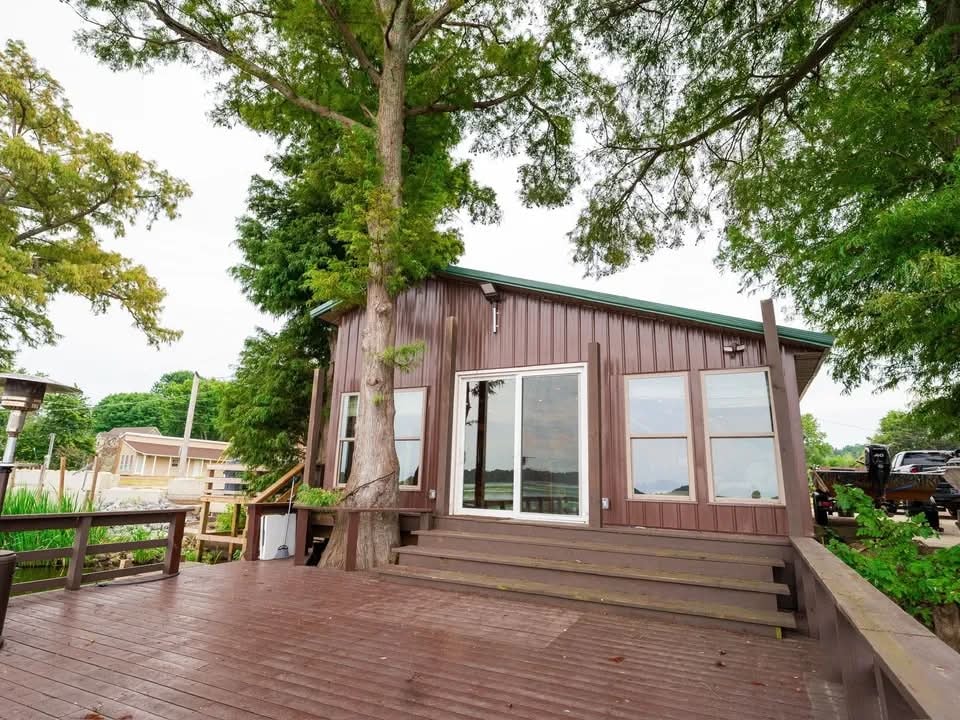 Lakeside Luxury Lodge exterior deck with cypress tree