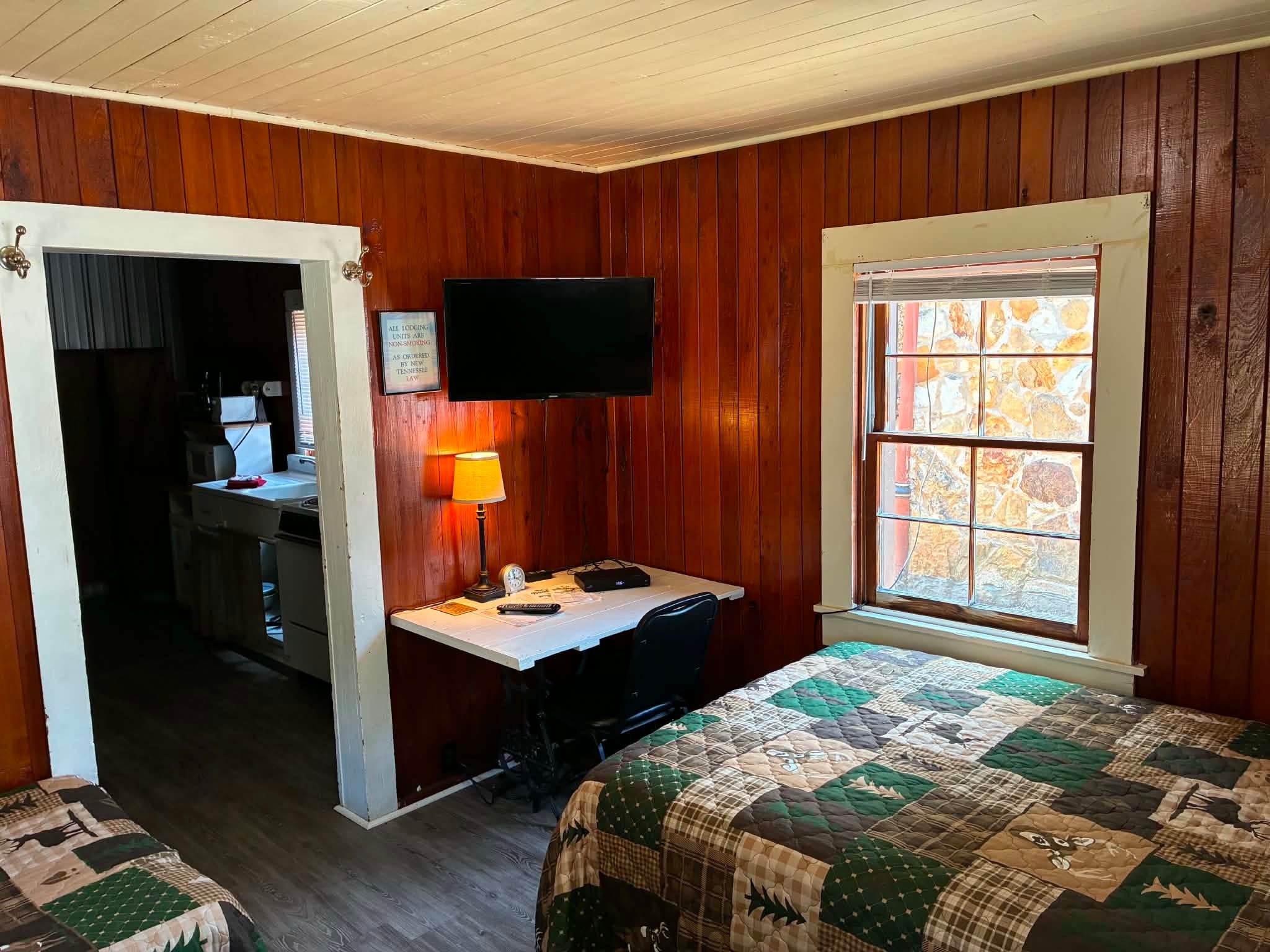 Standard Cabin bedroom with wood paneling and TV