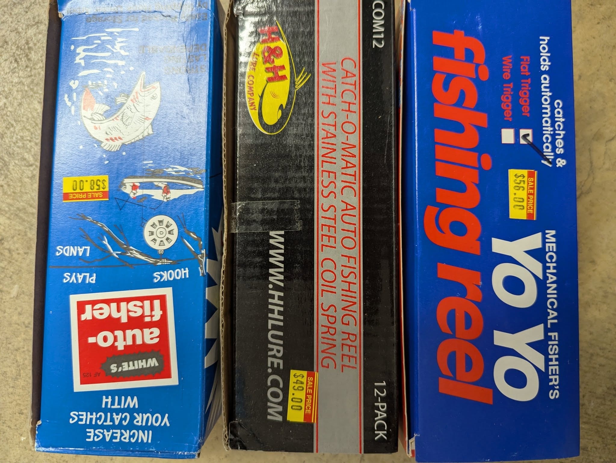 Vintage fishing reel and tackle boxes on display