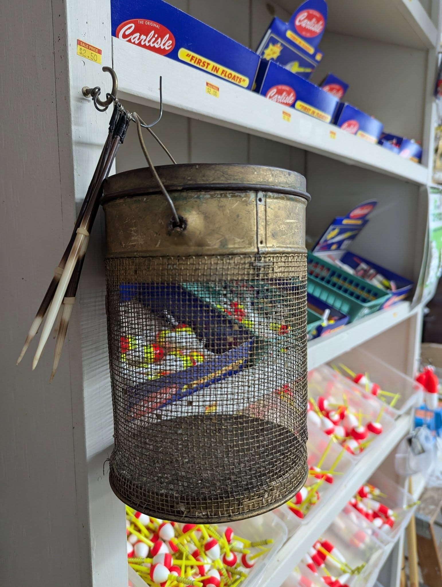 Vintage Carlisle float display and mesh bait bucket in the shop