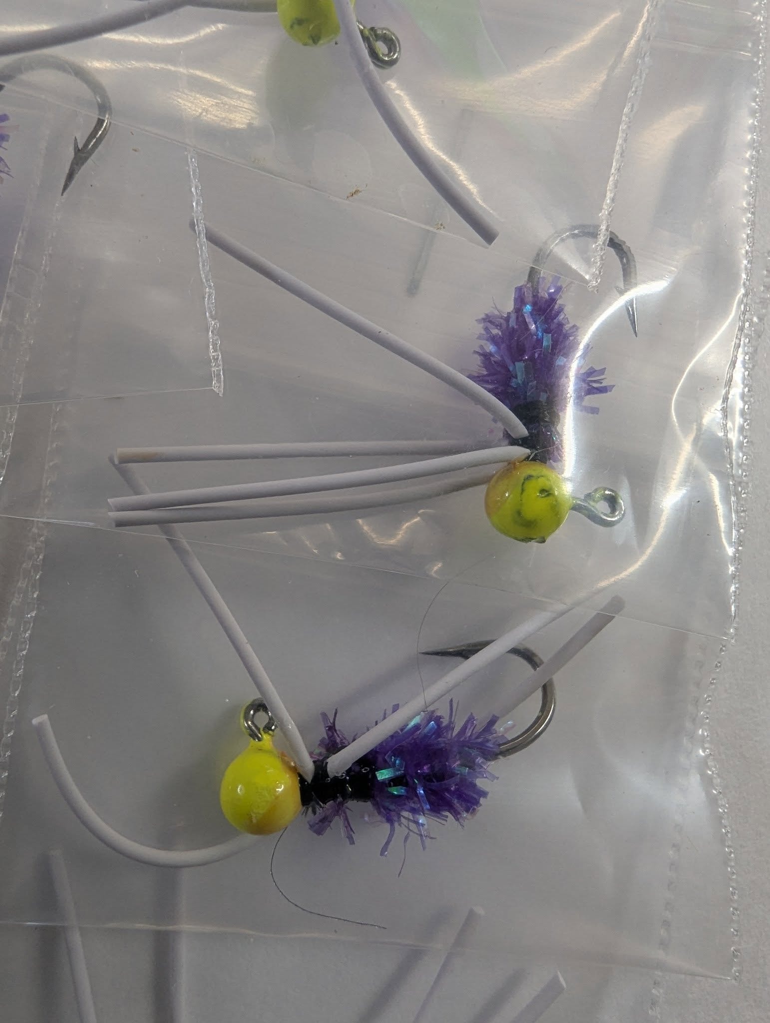 Purple and yellow Southshore crappie jig bugs close-up