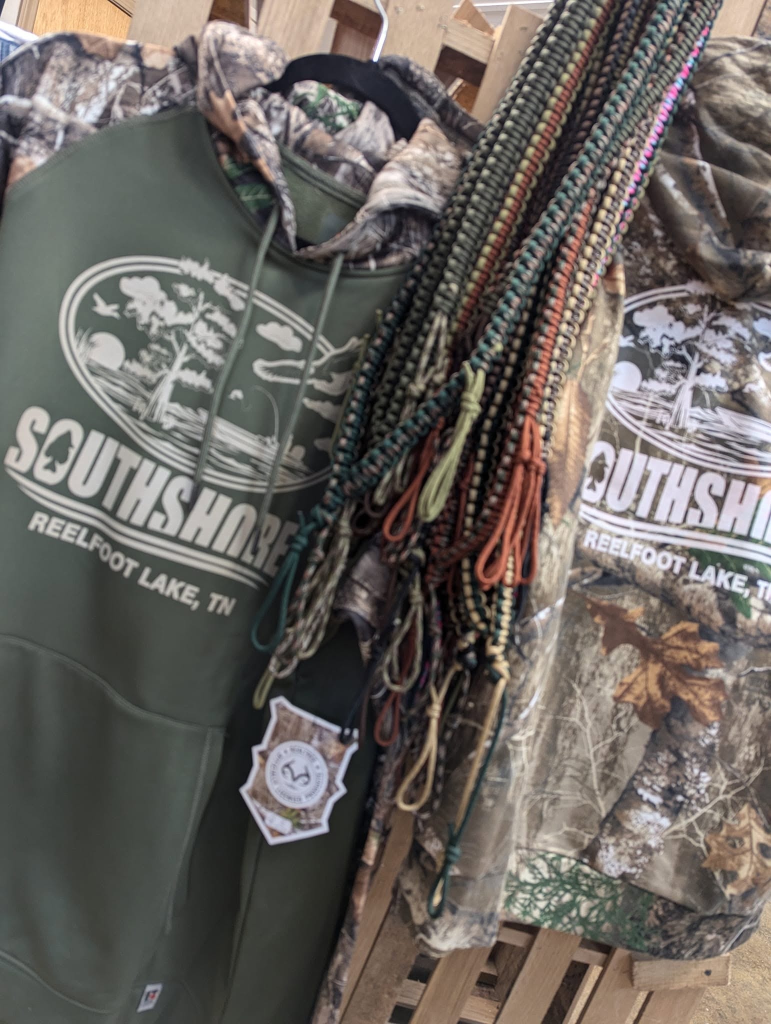 Southshore Resort branded hoodie and camo jacket with duck call lanyards