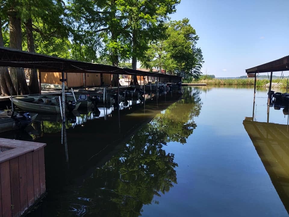Southshore Resort covered boat slips reflected in calm water