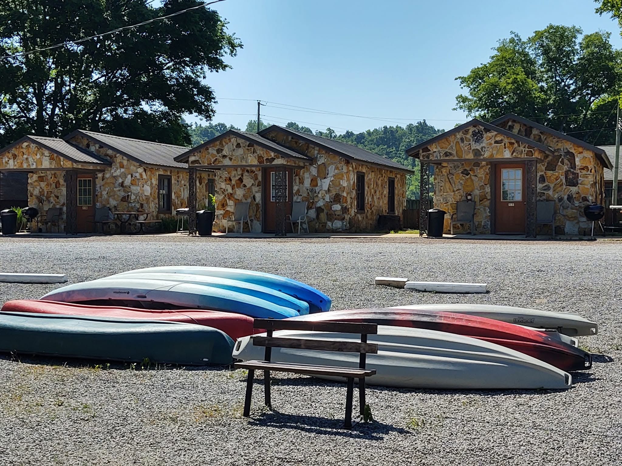 Kayaks and canoes stacked outside Southshore Resort stone cabins