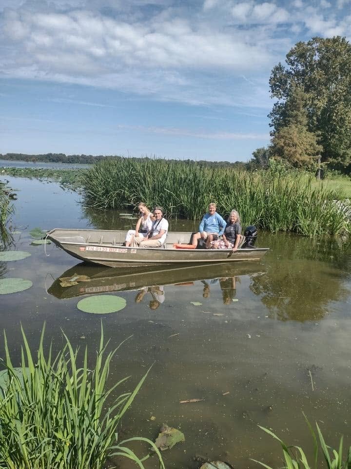 Family of four enjoying a jon boat ride on Reelfoot Lake