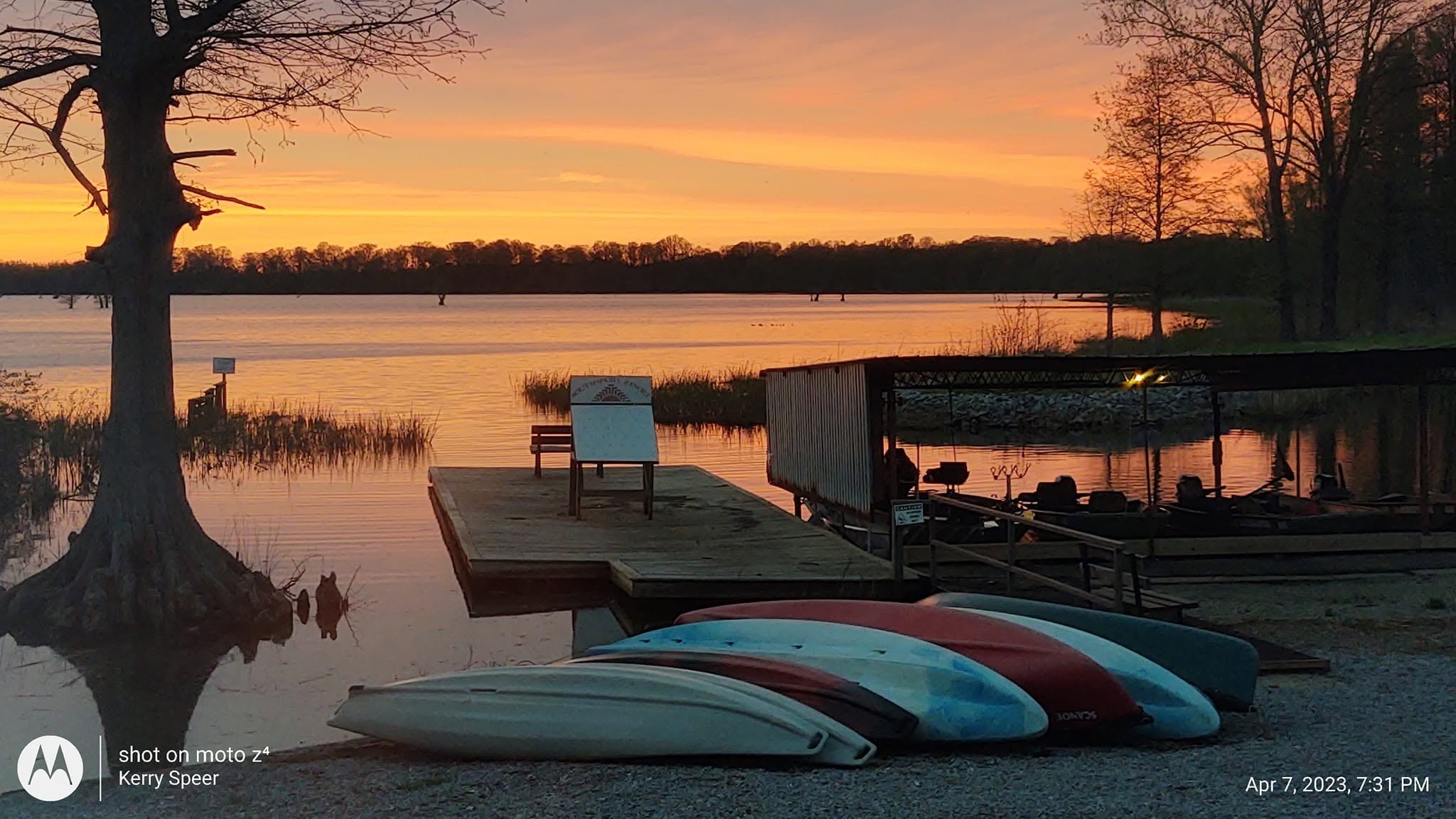 Colorful kayaks lined up at the Southshore Resort dock at golden sunset