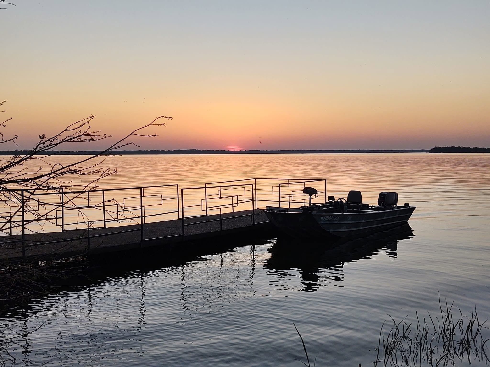Fishing boat docked at sunset on Reelfoot Lake