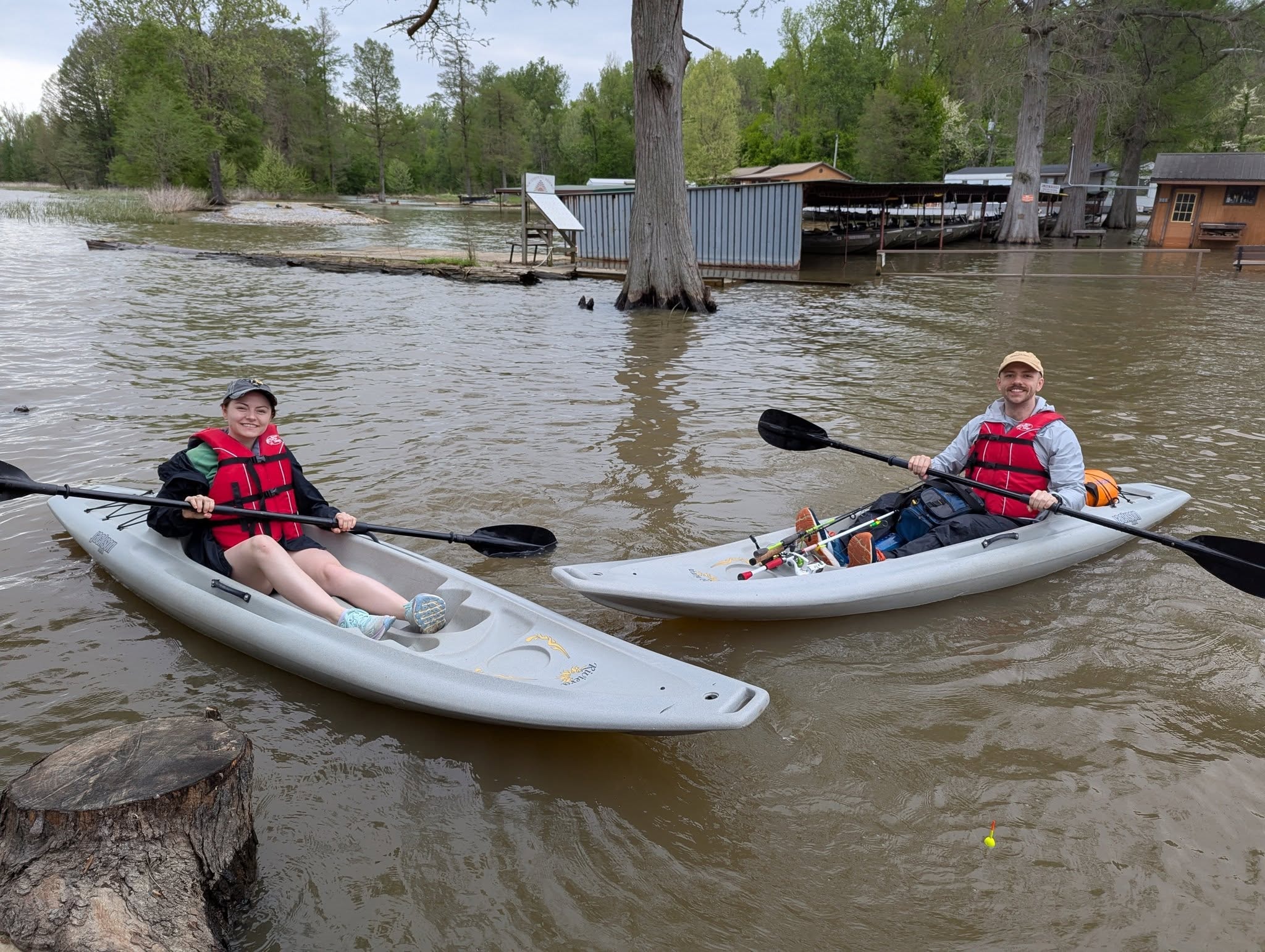 Two kayakers paddling on Reelfoot Lake near the resort dock