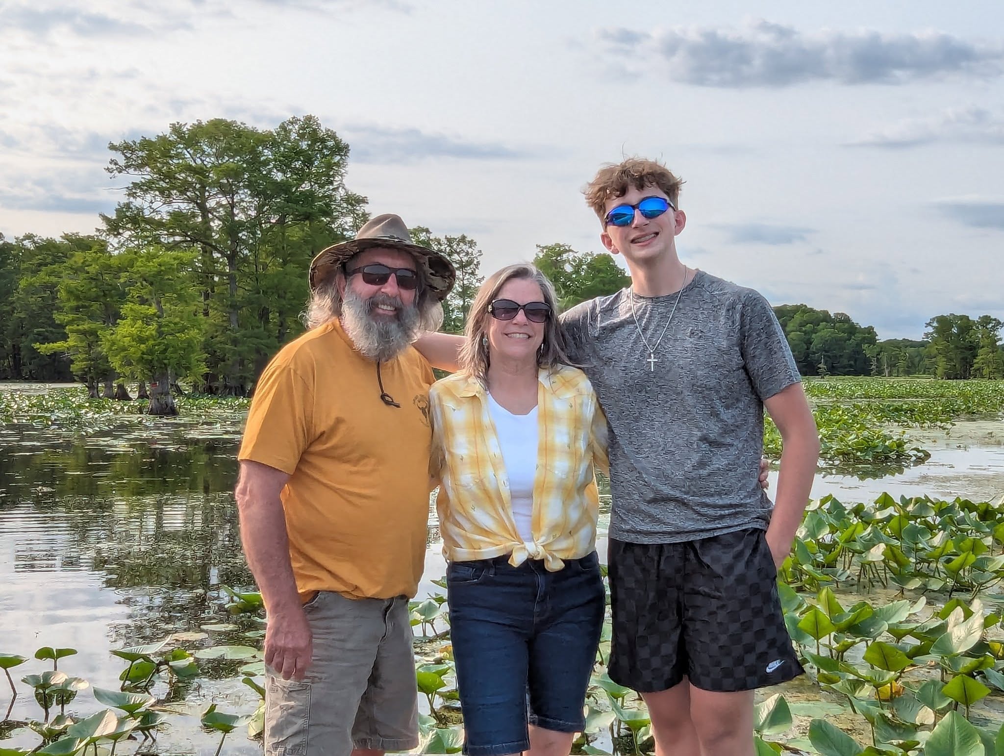 Family smiling together surrounded by lotus pads on Reelfoot Lake