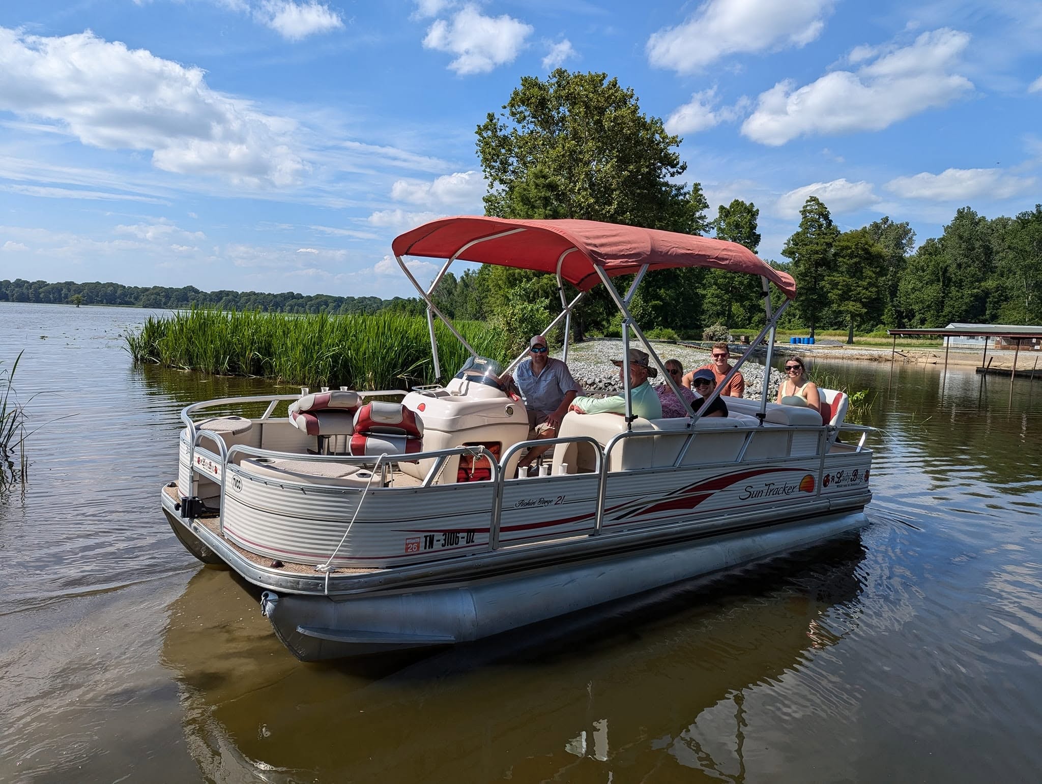 Guests on a SunTracker pontoon boat tour on Reelfoot Lake