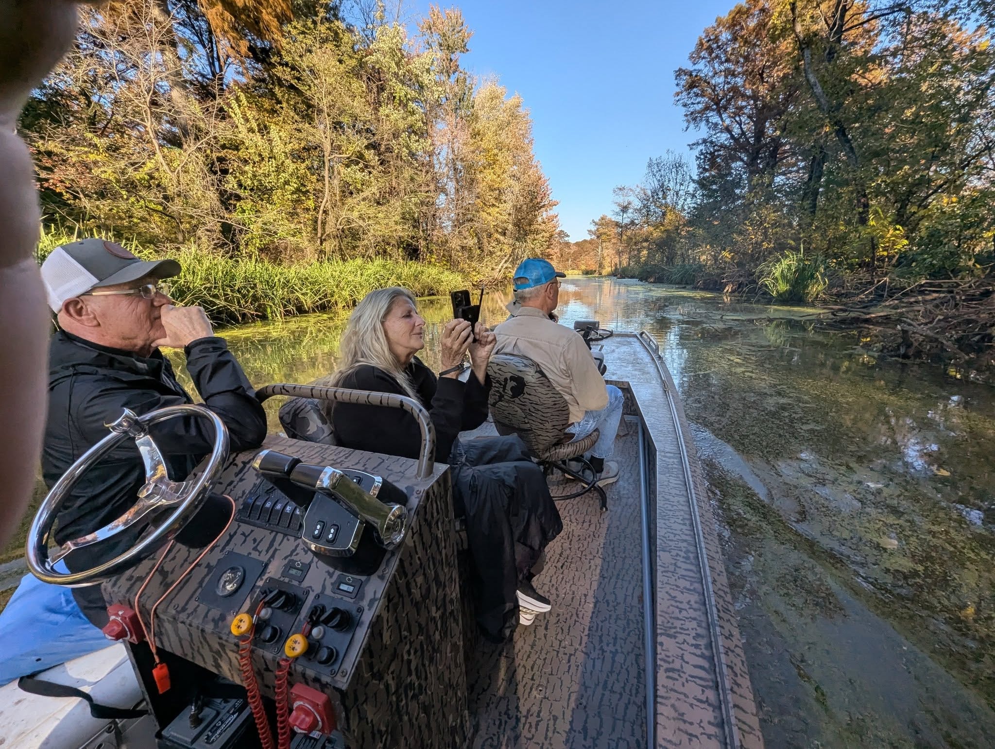 Guests using binoculars and cameras on a Reelfoot Lake nature tour