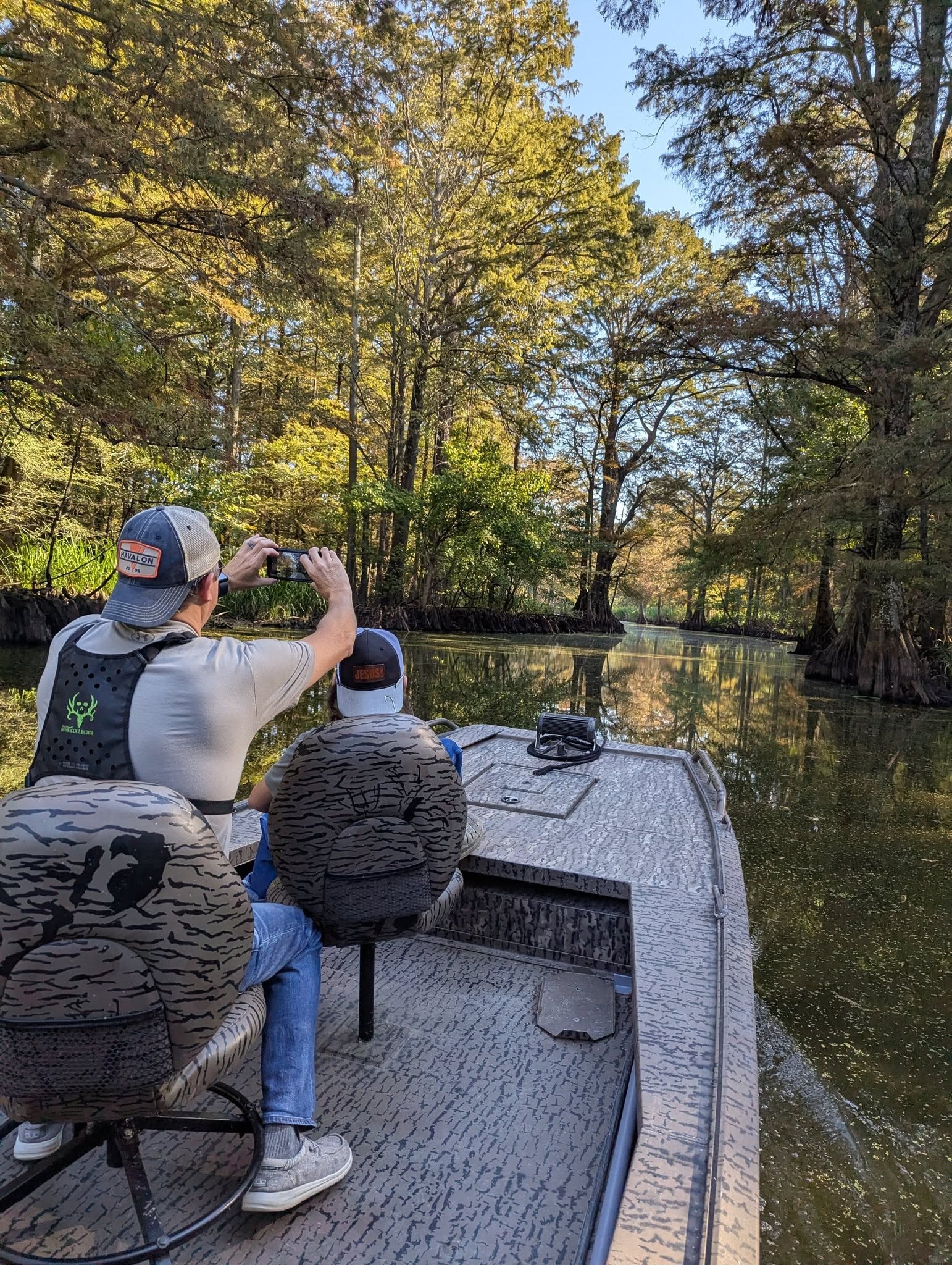 Guests photographing the cypress forest on a Reelfoot Lake tour