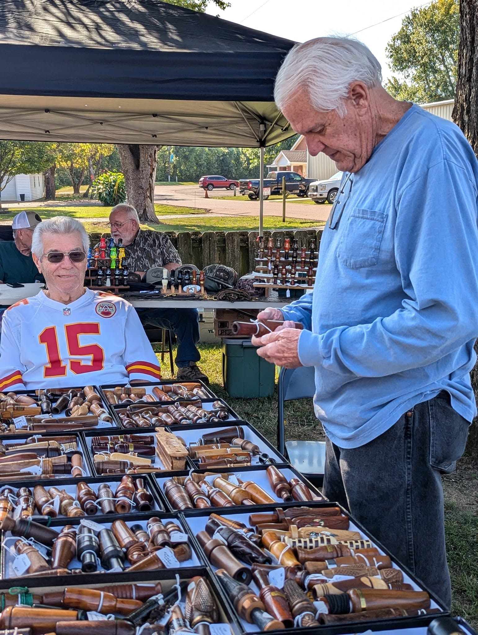 Duck call collector browsing displays at the festival