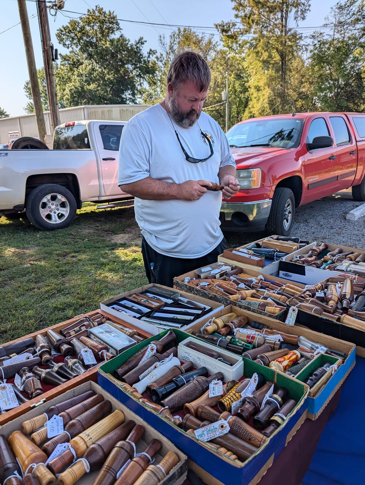 Man showing duck calls at outdoor market
