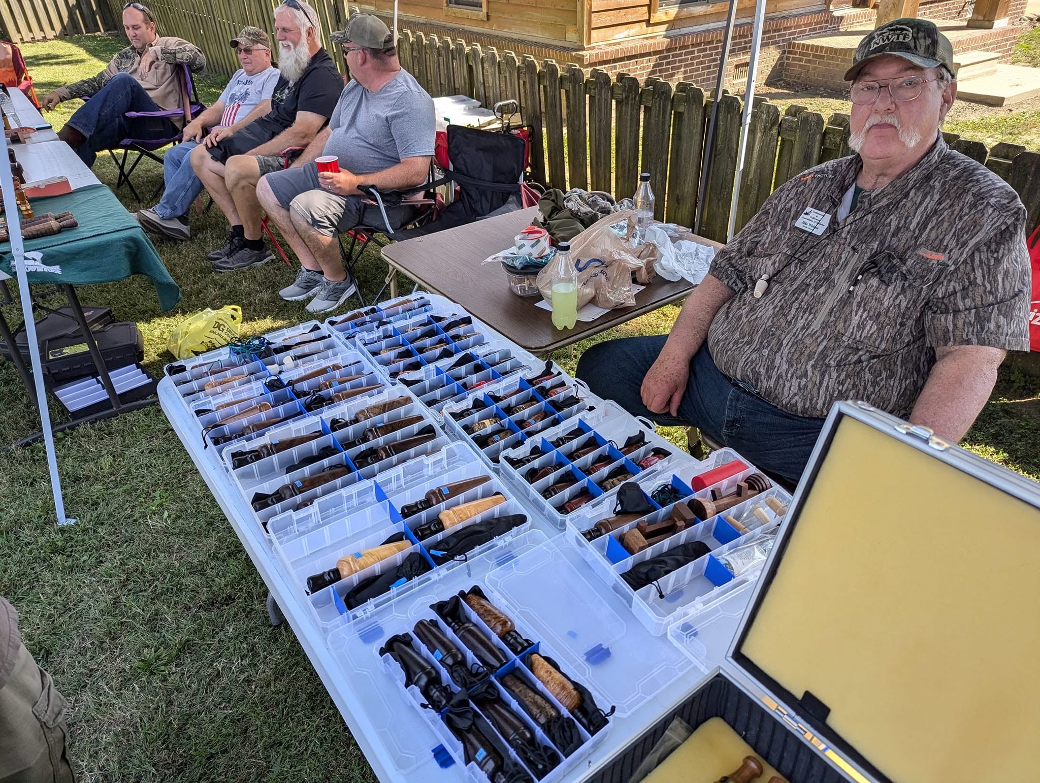 Duck call collectors displaying organized cases at the festival