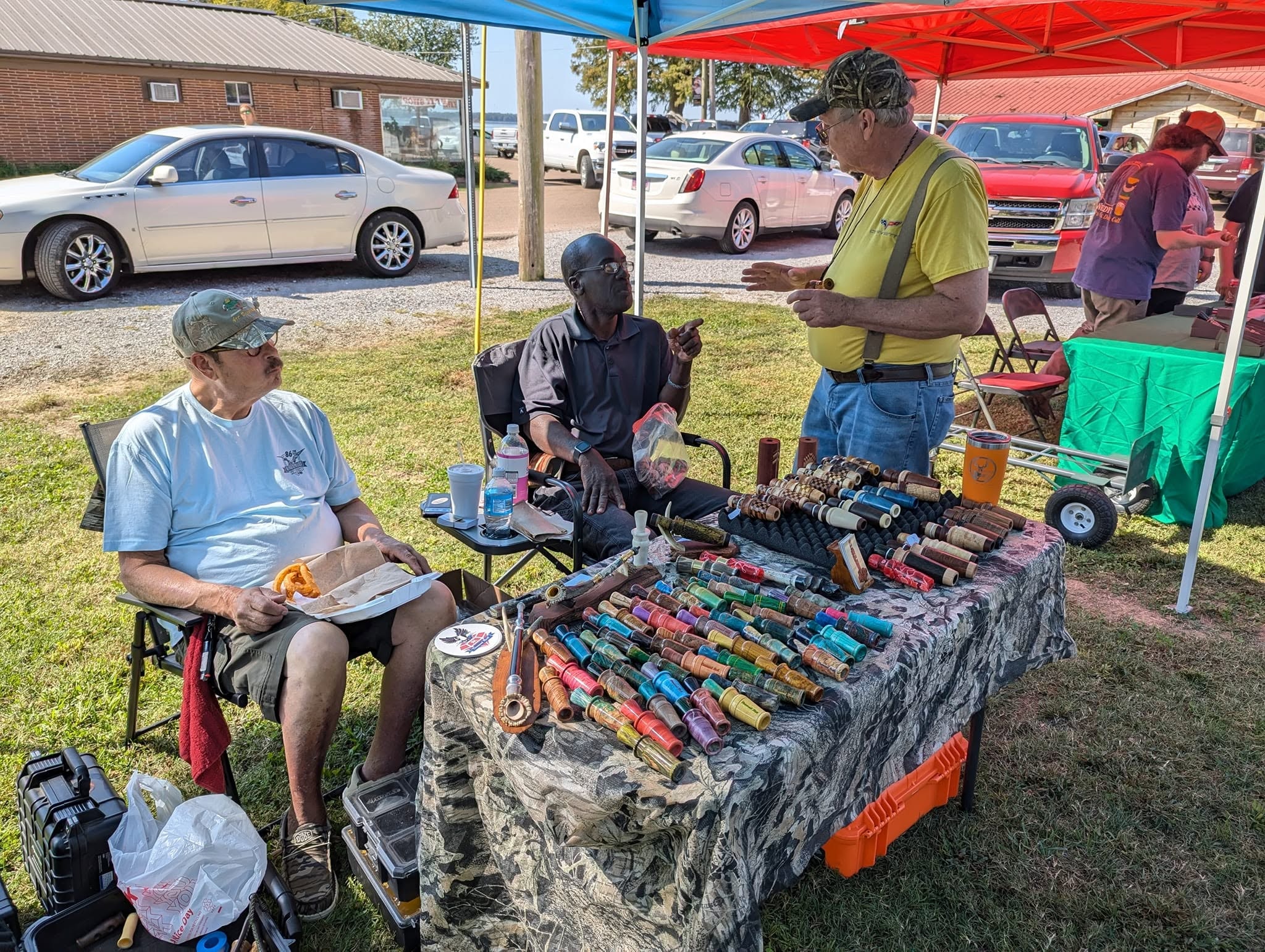 People examining duck calls and collectibles outdoors