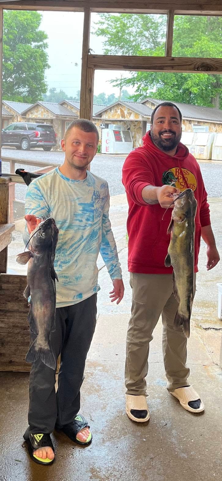 Two anglers holding big catfish
