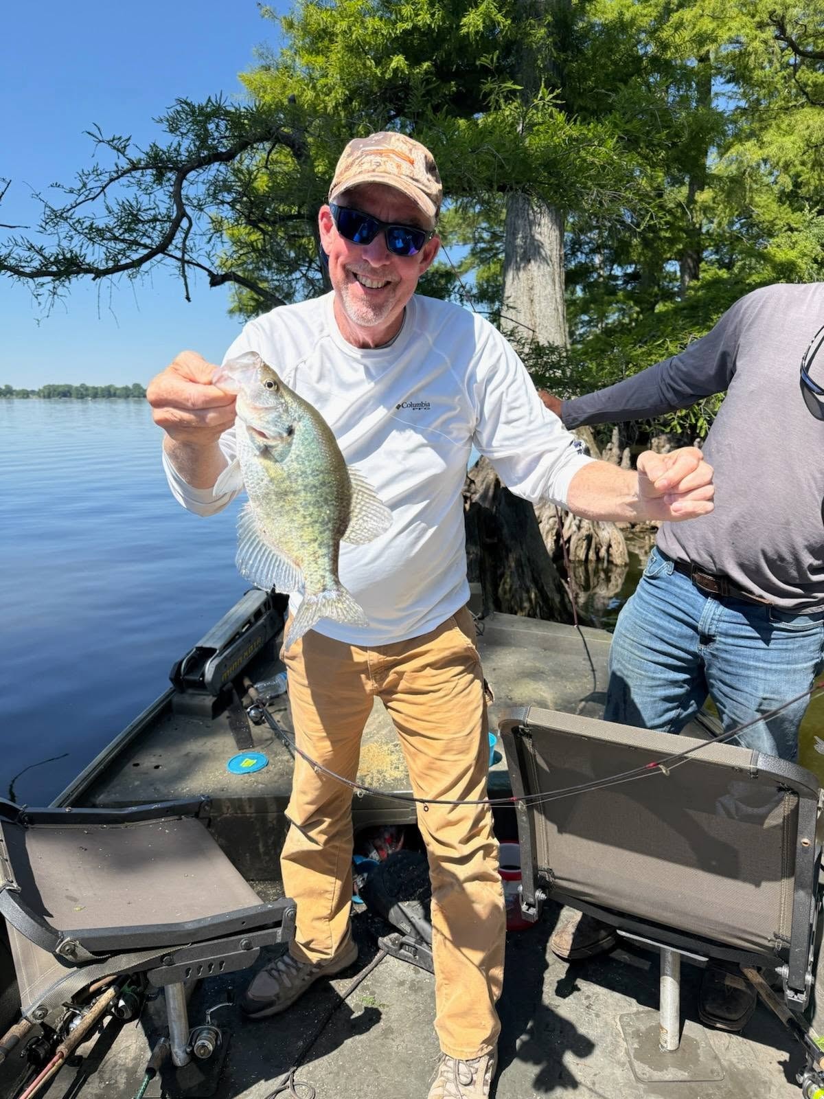 Angler holding a crappie on the boat at Reelfoot Lake