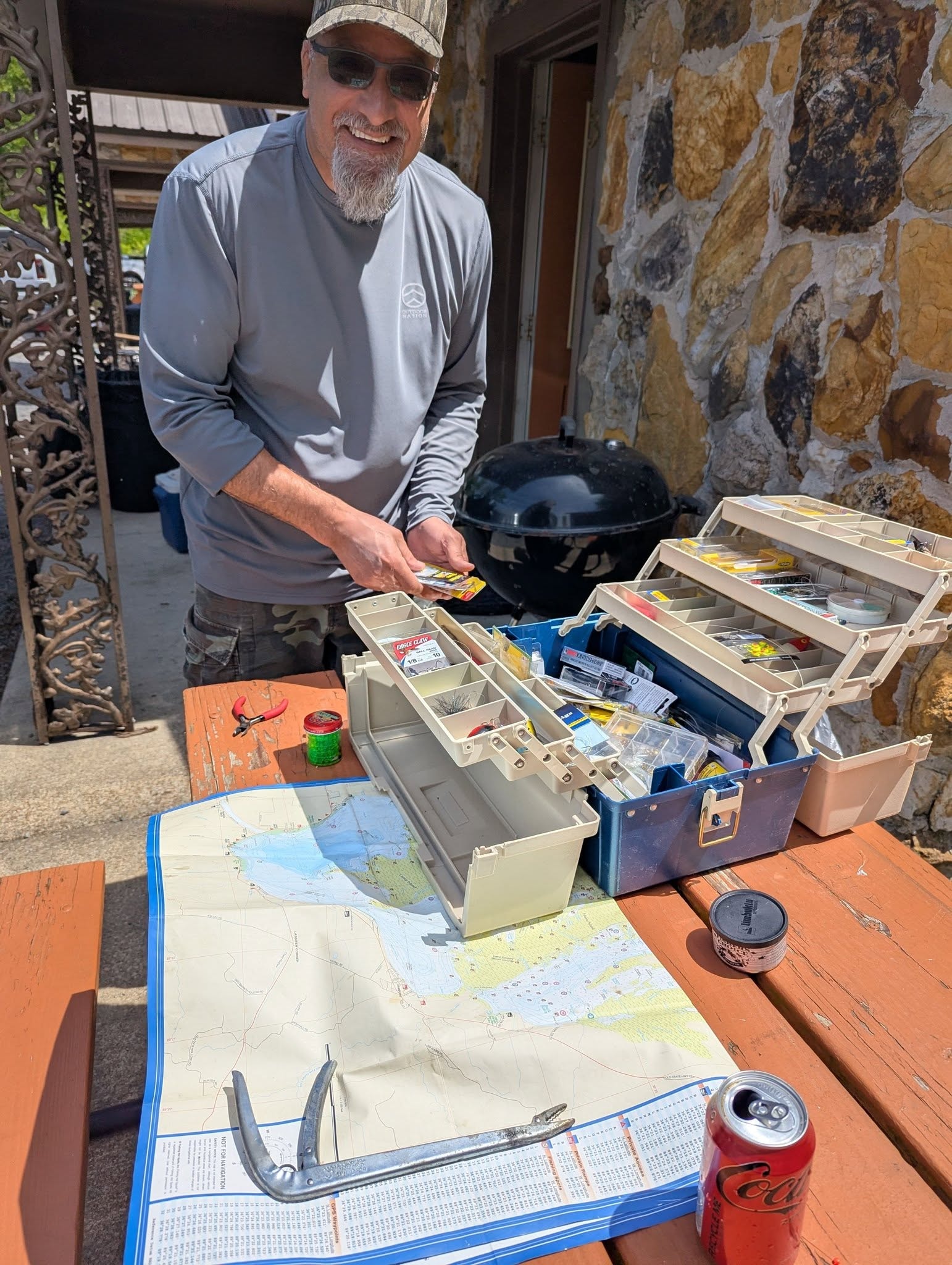 Angler sorting tackle box with lake map at Southshore Resort