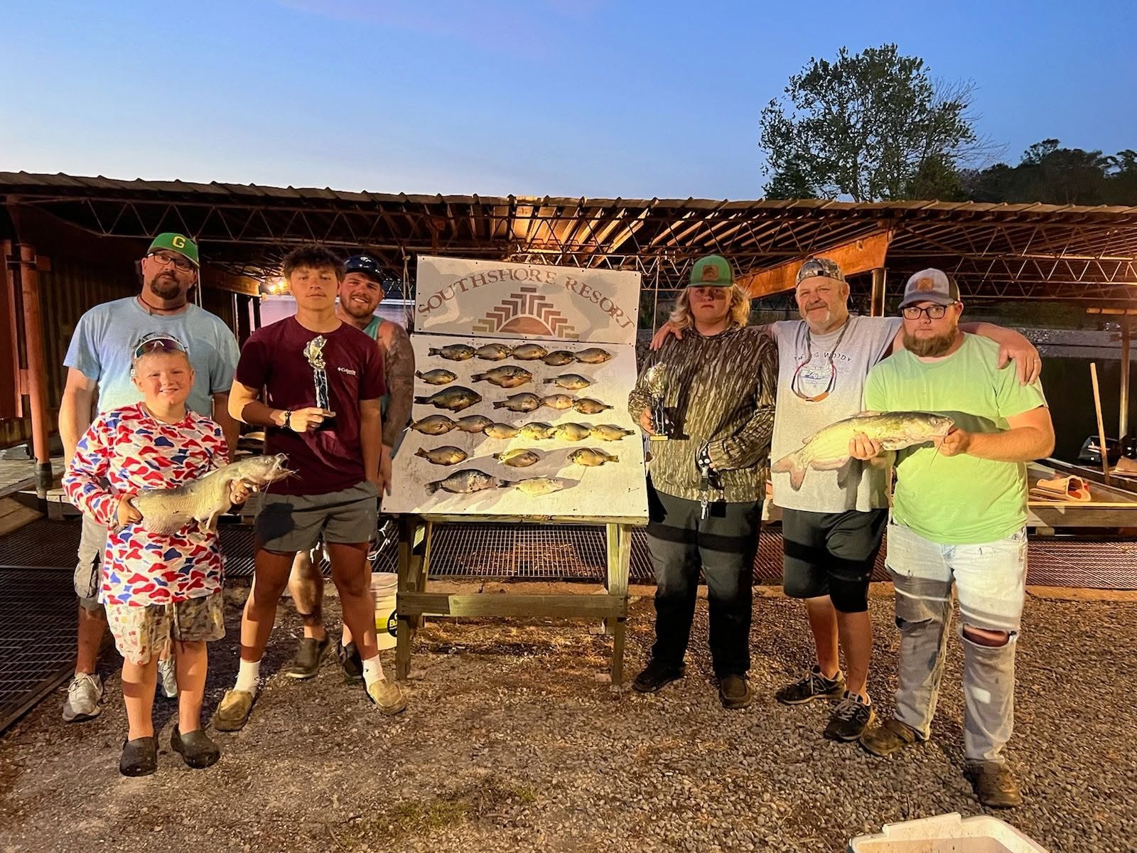 Group of guests with crappie and catfish at the Southshore Resort board