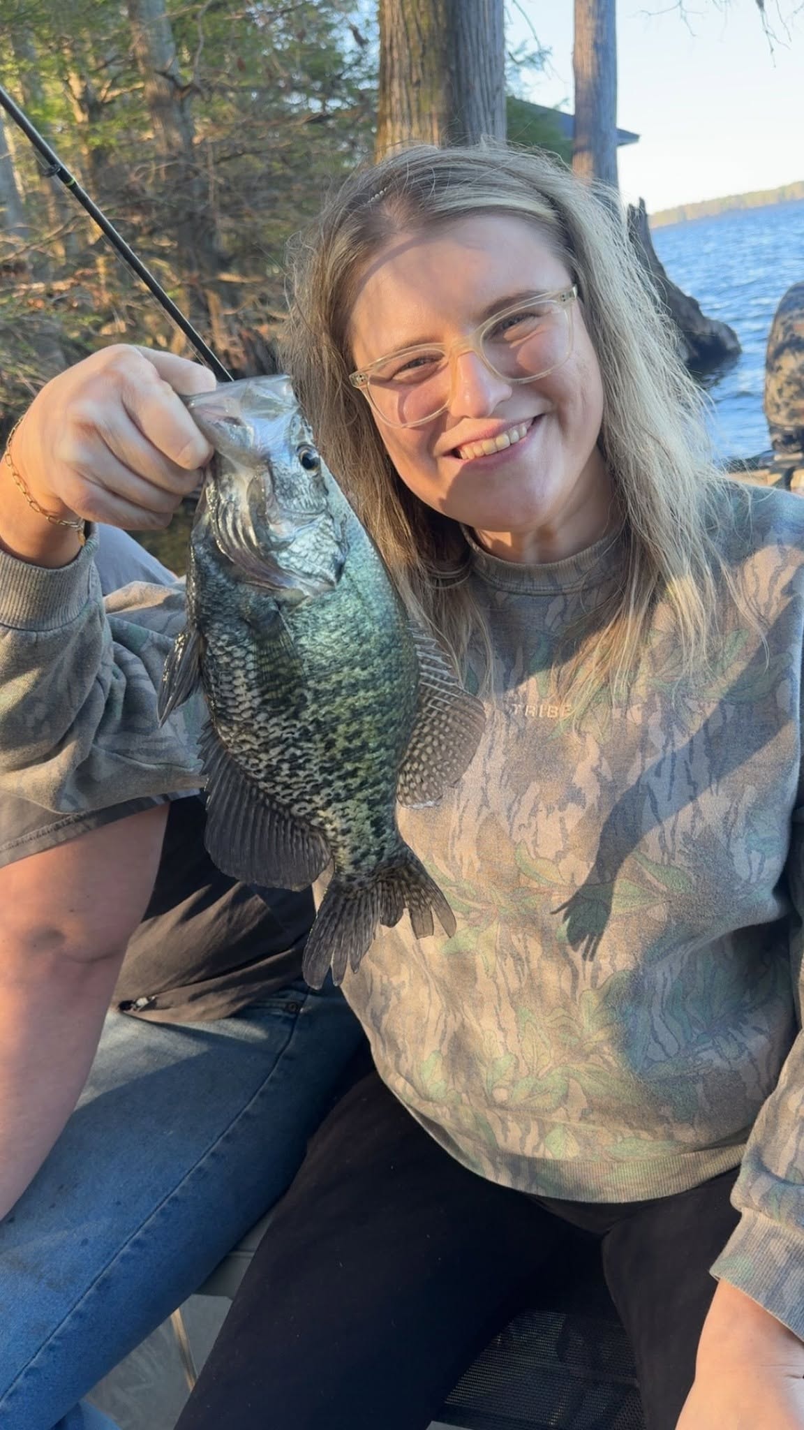 Young woman holding a big crappie on the boat at Reelfoot Lake