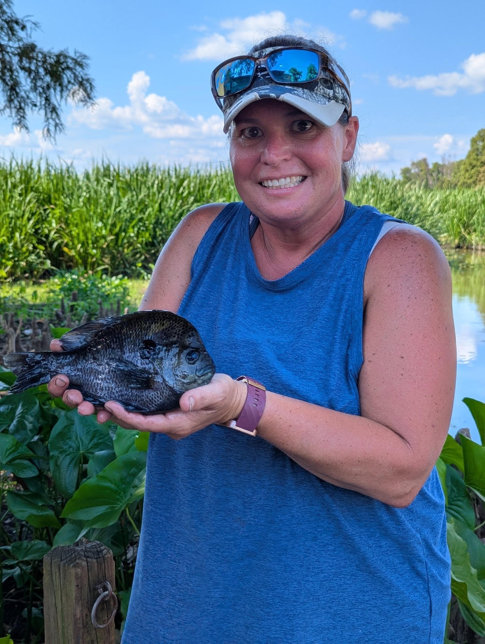 Woman holding a big bluegill by the lily pads at Reelfoot Lake