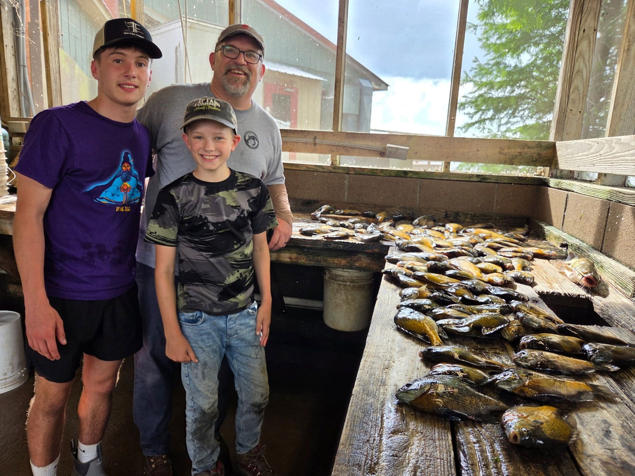 Family with crappie haul at the cleaning station