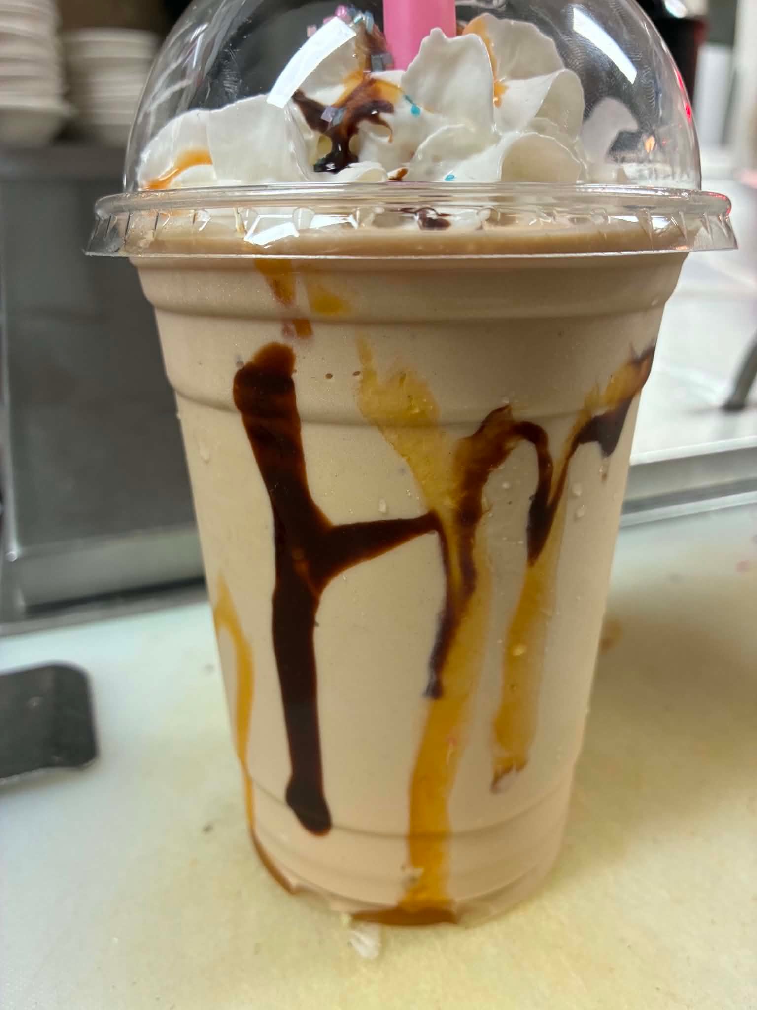 Caramel and chocolate drizzle Quake Shake with whipped cream at The Boat House Restaurant