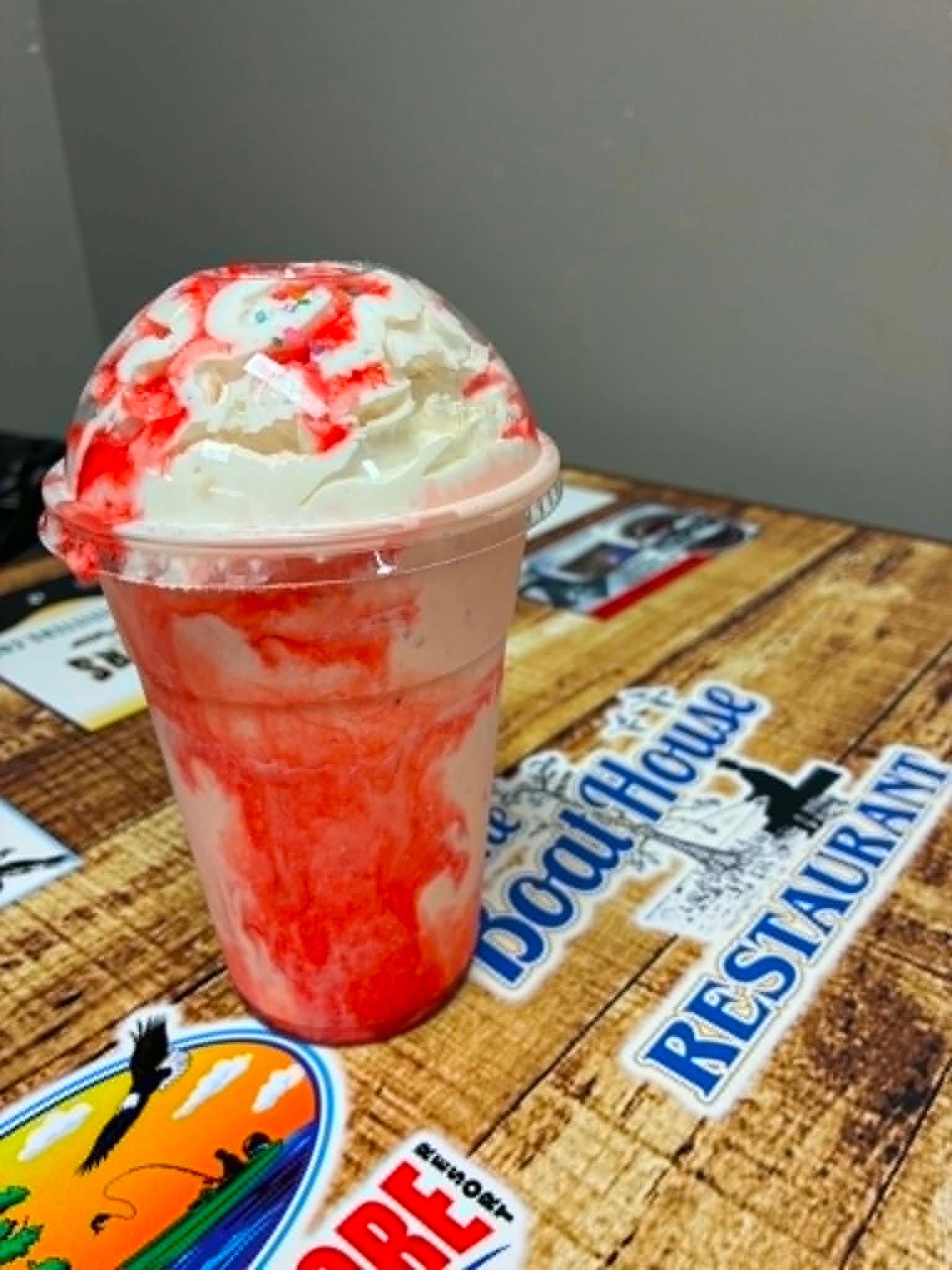 Strawberry Quake Shake with whipped cream and sprinkles on a Boat House Restaurant table