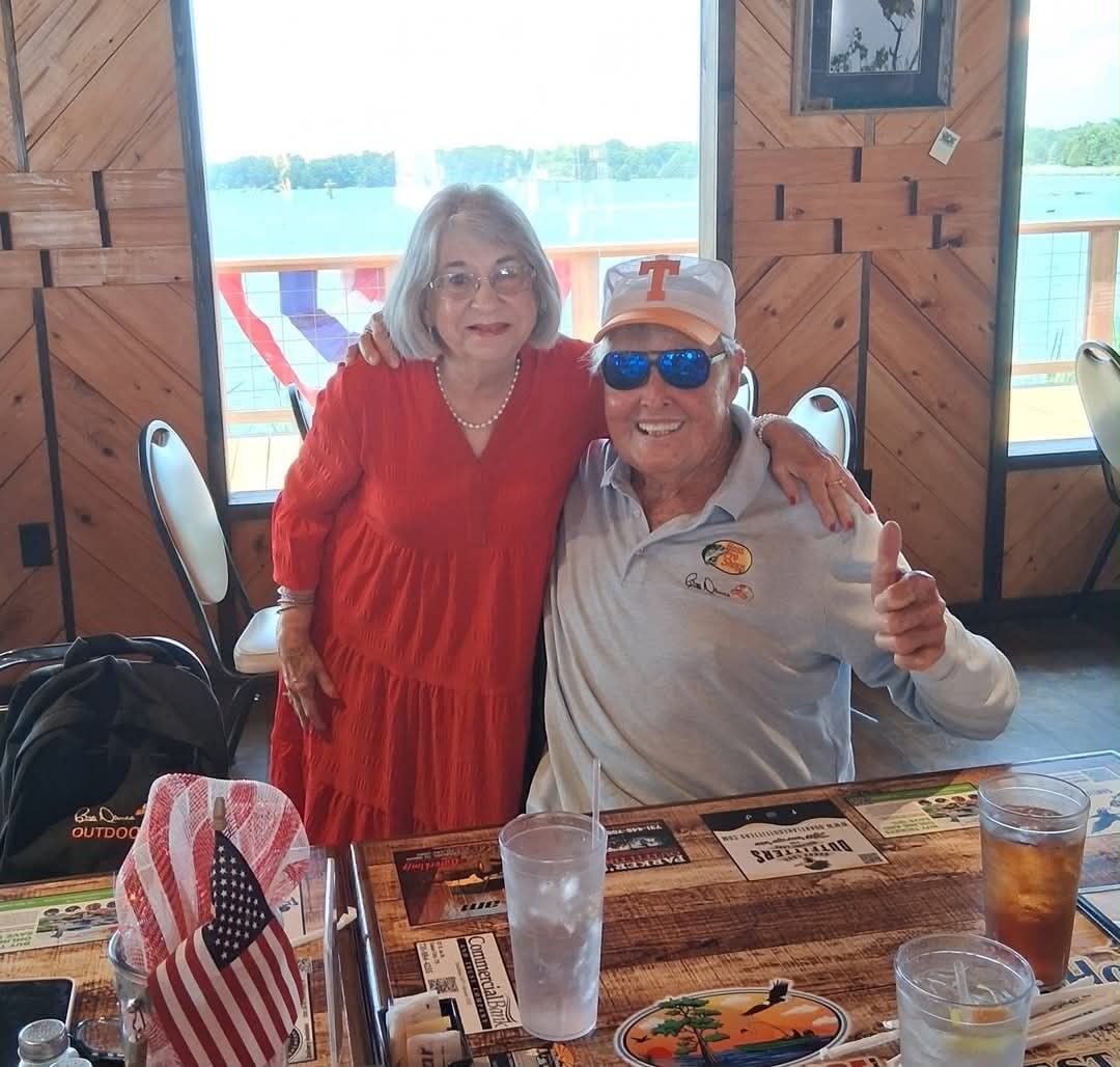 Couple smiling together at The Boat House Restaurant with Reelfoot Lake views