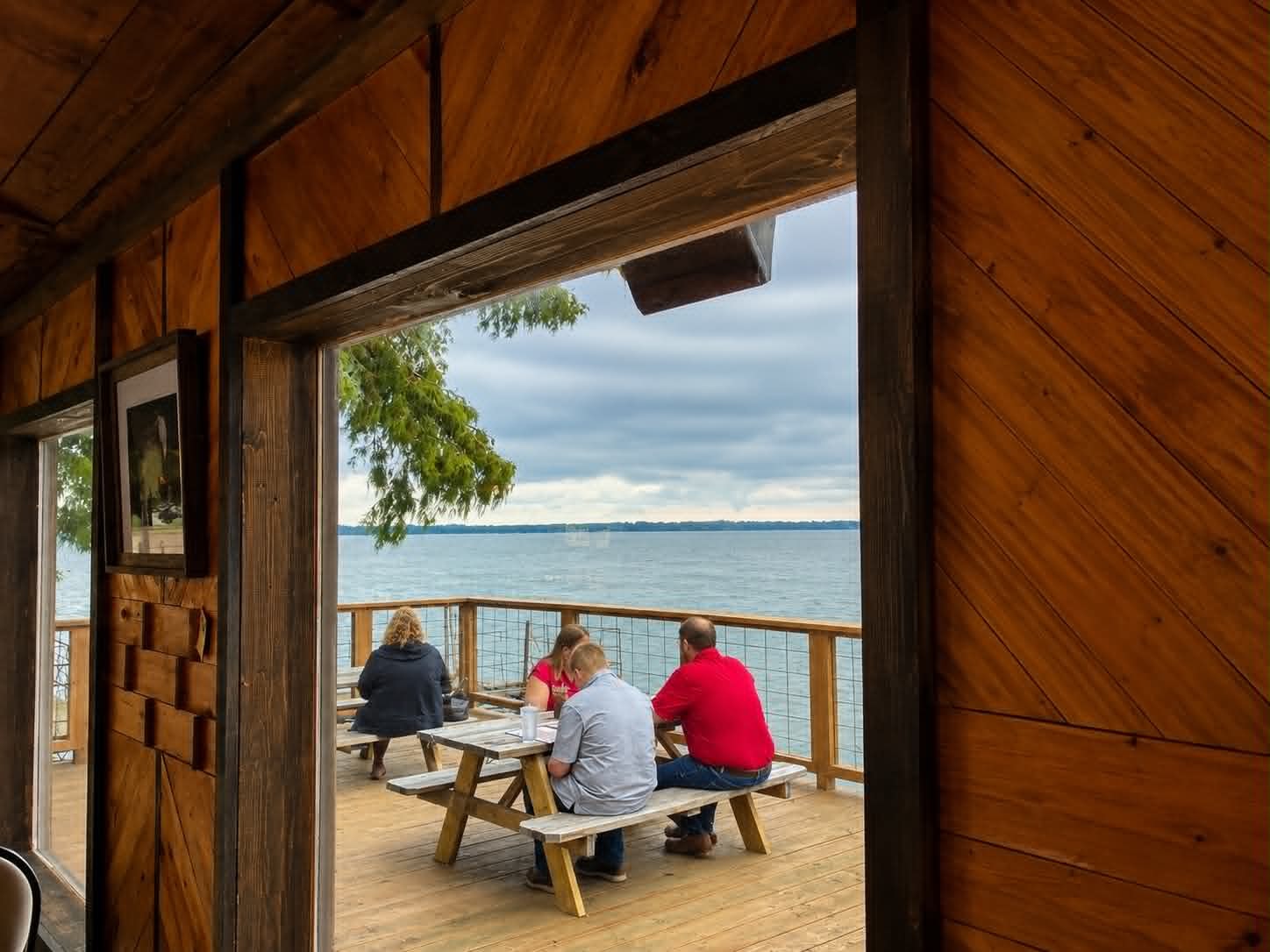Guests dining on the lakeside deck at The Boat House Restaurant overlooking Reelfoot Lake