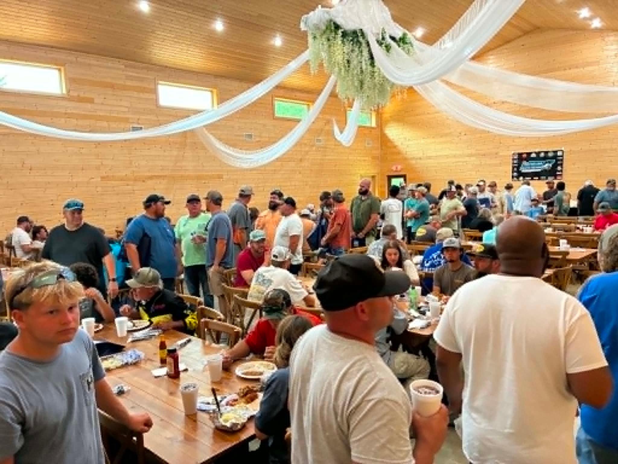 Packed community event in the Southshore Resort event hall with draped ceiling decorations