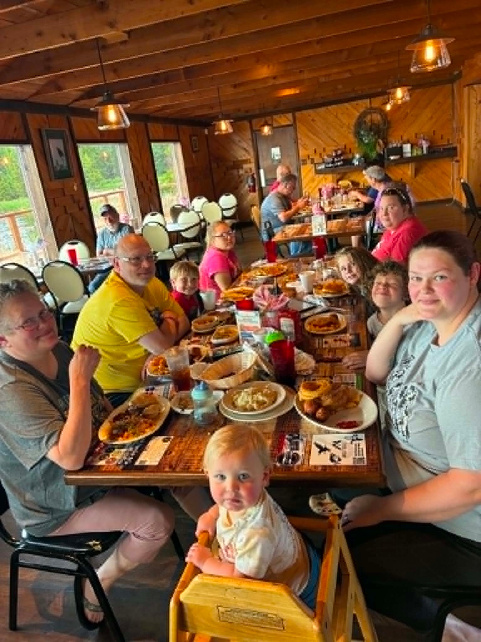 Large multi-generational family sharing a full meal together at The Boat House Restaurant