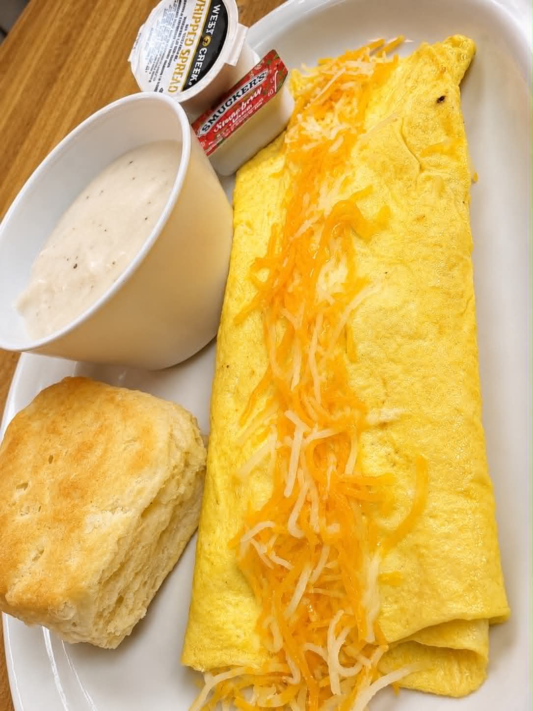 Cheese omelet with biscuit, gravy and jelly at The Boat House Restaurant
