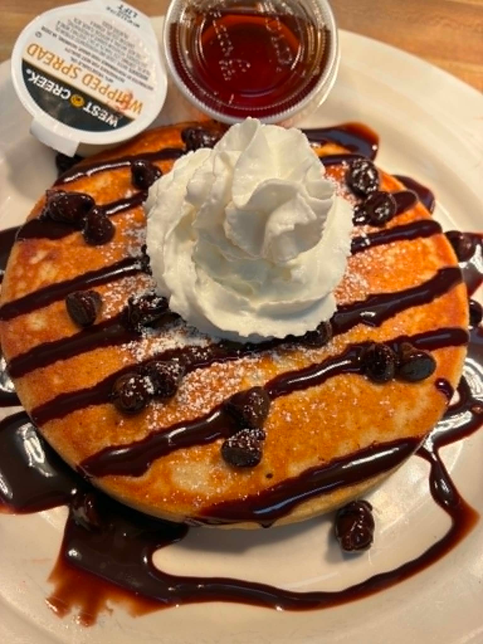 Chocolate chip pancake with whipped cream and chocolate drizzle at The Boat House Restaurant