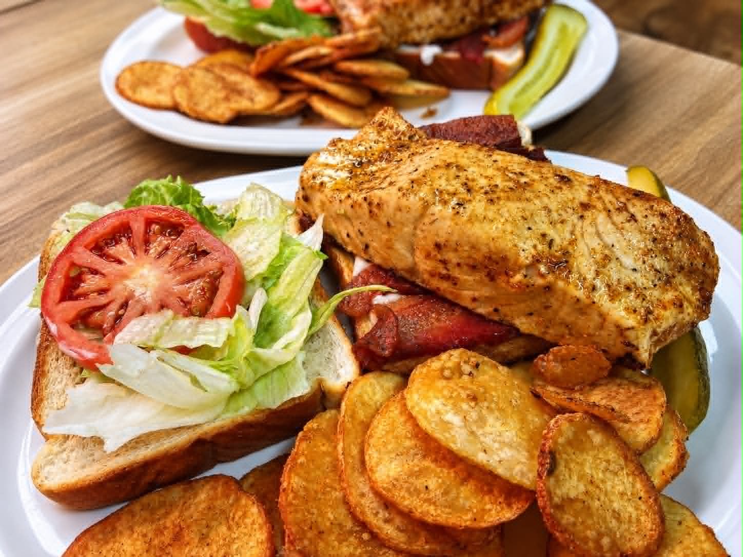 Grilled chicken sandwich with lettuce, tomato and homemade chips at The Boat House Restaurant