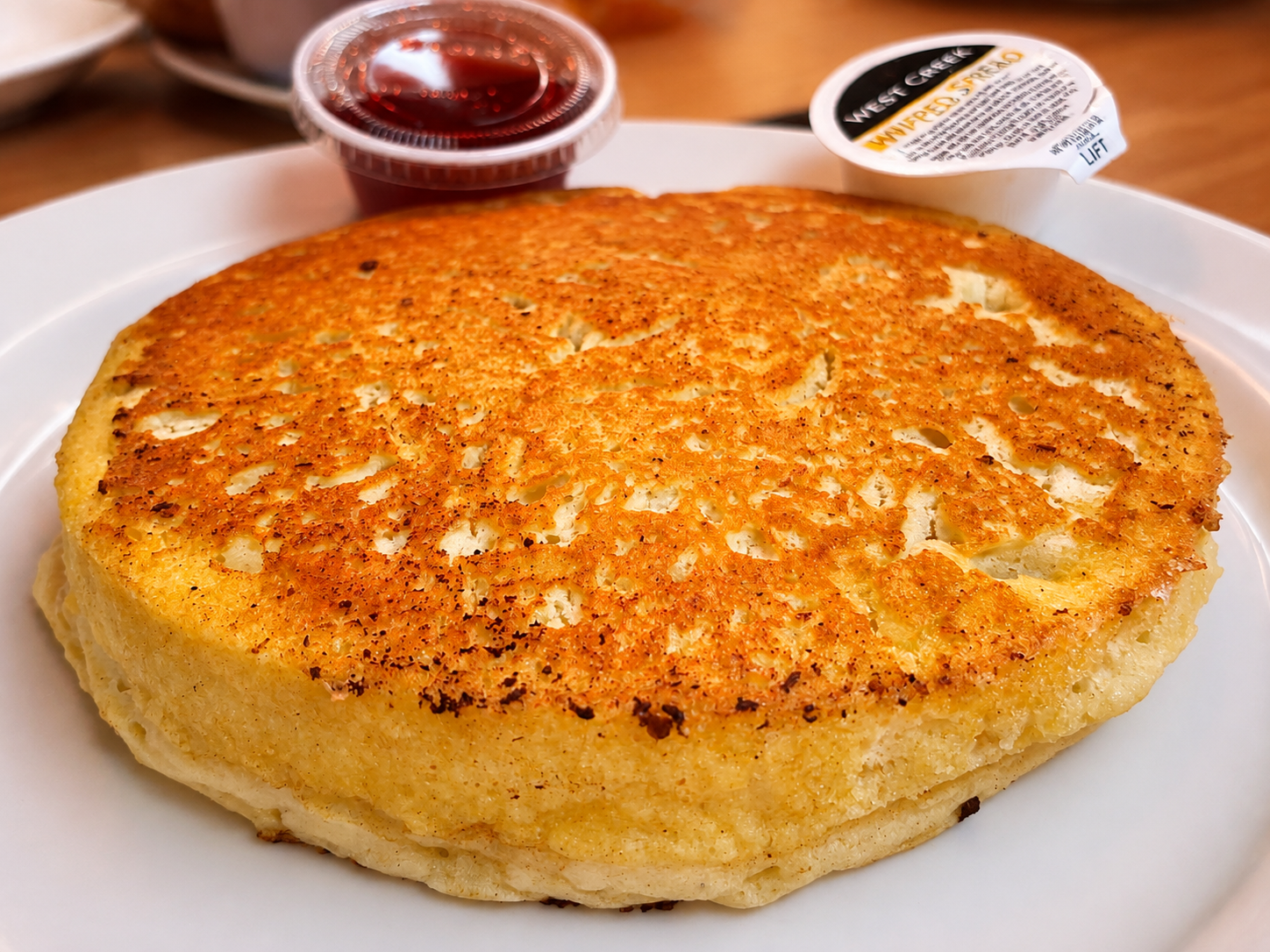 Golden buttermilk pancake with jelly at The Boat House Restaurant