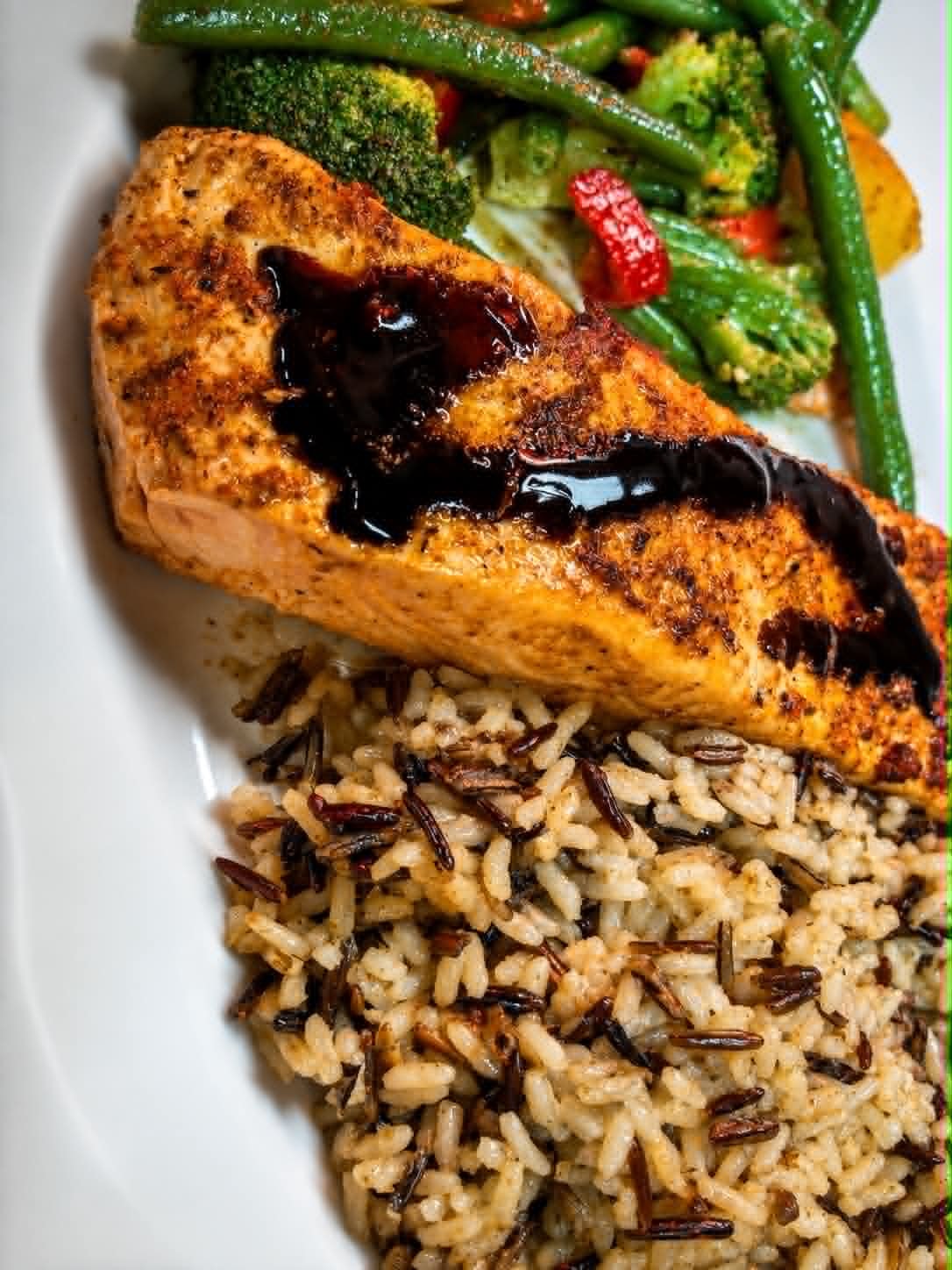 Blackened salmon with wild rice and sautéed vegetables at The Boat House Restaurant