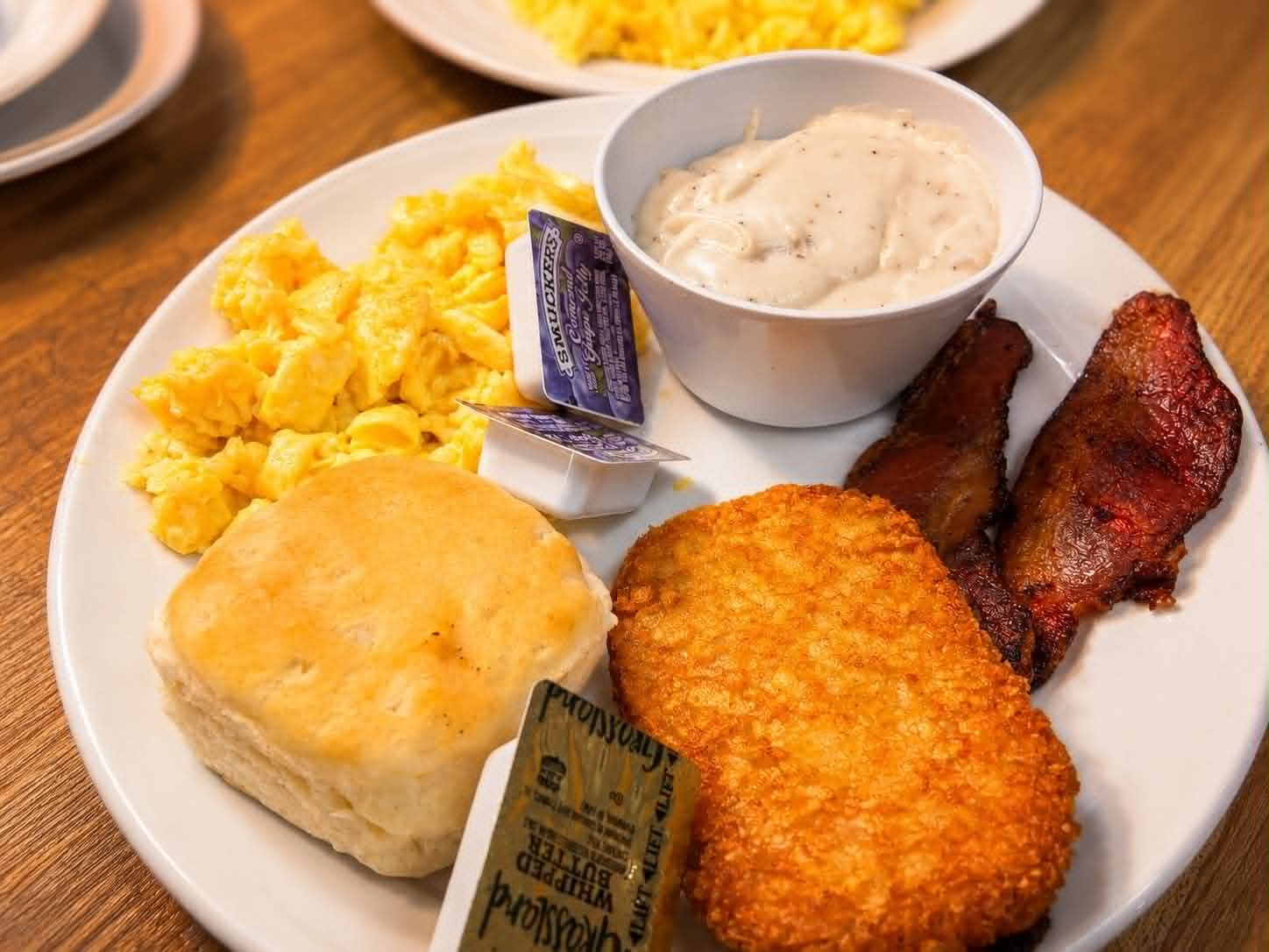 Scrambled eggs, biscuit, hash brown and gravy with bacon at The Boat House Restaurant