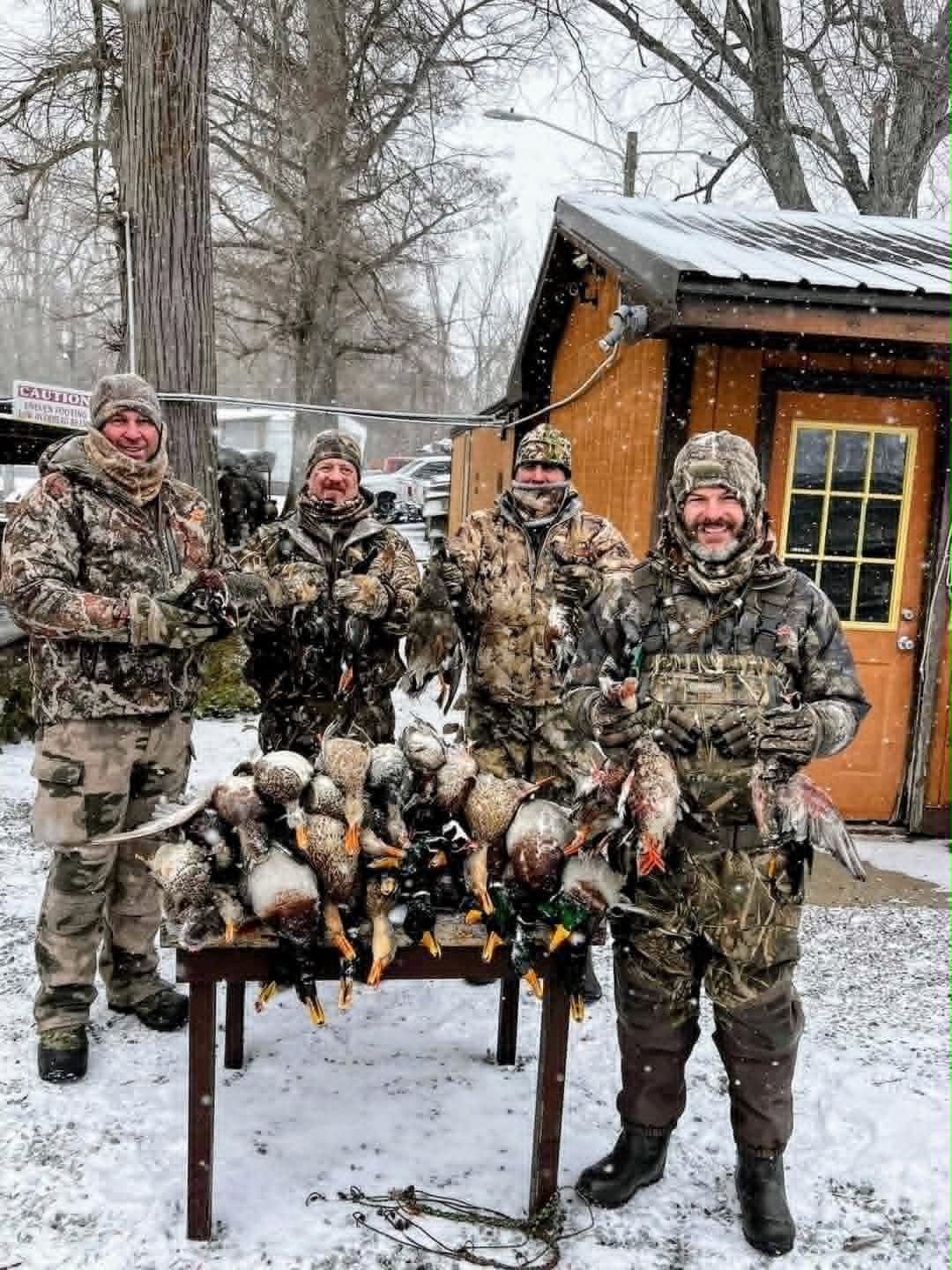 Hunters posing with duck hunting catch