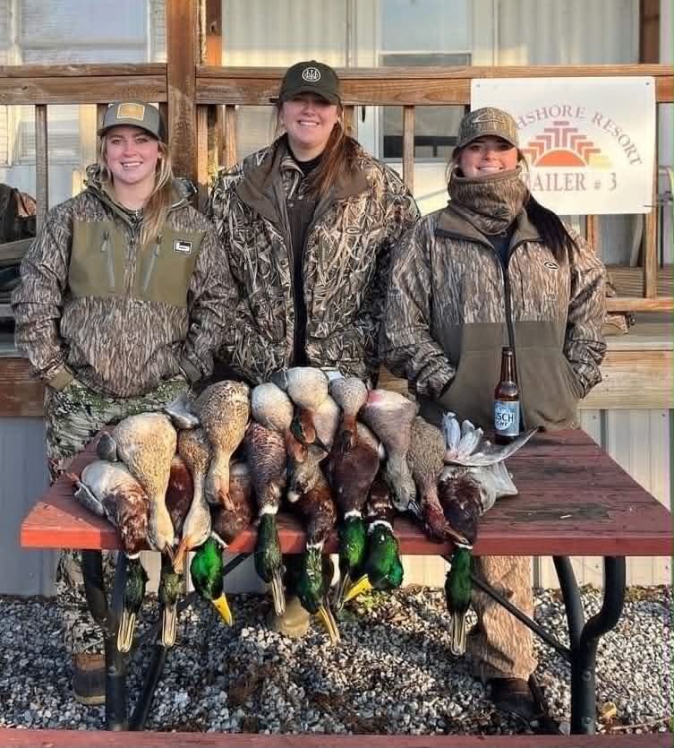 Hunters displaying duck hunting catch